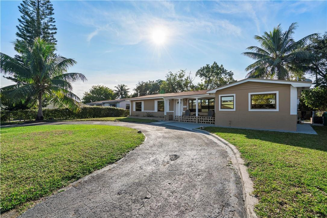 Undisclosed Address Miami, FL 33169 - Photo 3 of 24 a front view of house with yard and green space