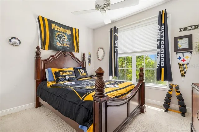 a bed sitting in a bedroom next to a window