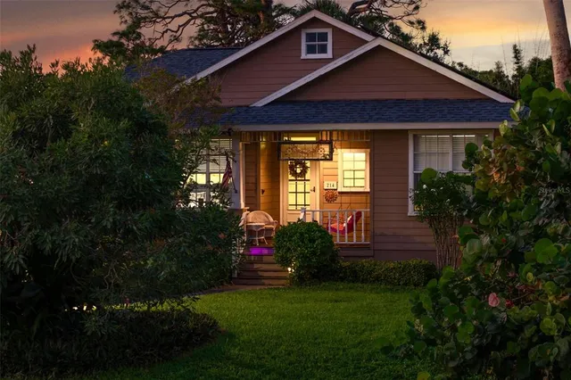 a front view of a house with a garden