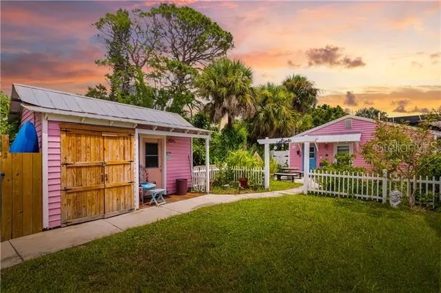 a front view of a house with a garden and yard
