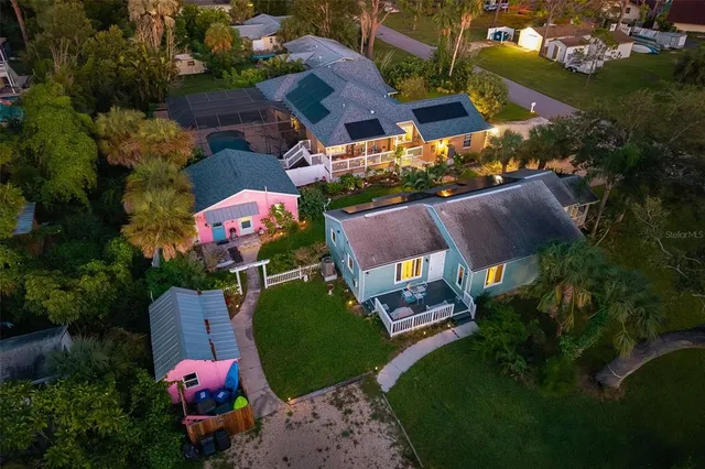 an aerial view of a house with a garden and swimming pool