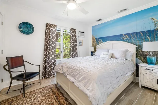 a bedroom with a bed a chair and a large window