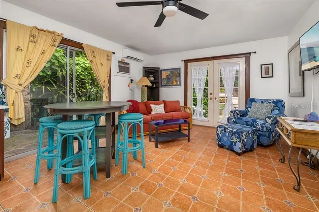 a living room with furniture and a floor to ceiling window