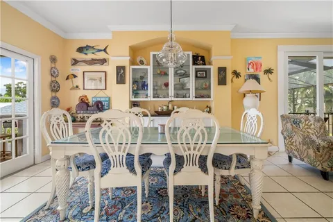 a view of a dining room with furniture and chandelier