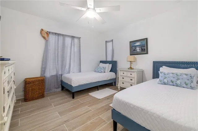 a bedroom with two beds and a chandelier