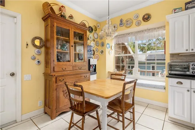 a dining area with a table and chairs