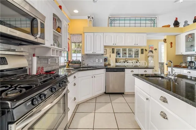 a kitchen with a stove a sink and a microwave
