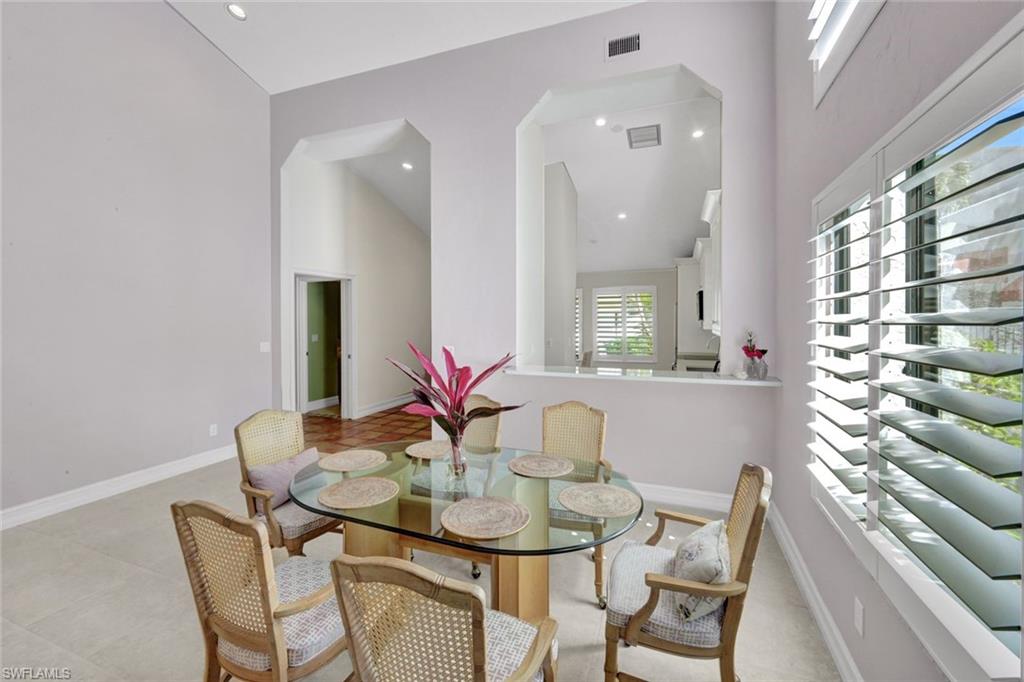 202 Bears Paw Trail, Unit 97 Naples, FL 34105 - Photo 13 of 28 a view of a dining room with furniture and a large window