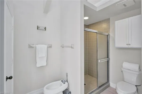 a white toilet sitting next to a bathroom sink