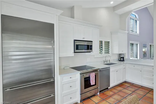a kitchen with a sink stove and microwave