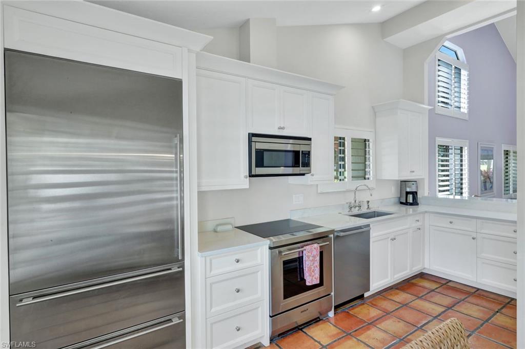202 Bears Paw Trail, Unit 97 Naples, FL 34105 - Photo 7 of 28 a kitchen with a sink stove and microwave