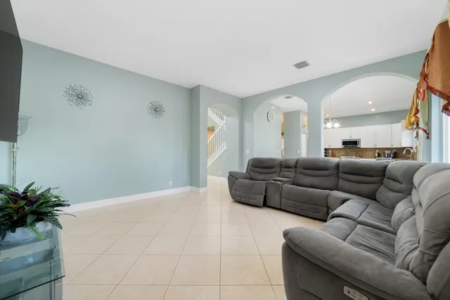 a living room with furniture and a potted plant