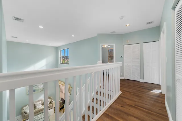a view of hallway with wooden floor