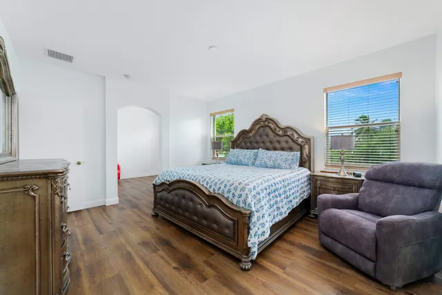 a bedroom with a bed couch and a window