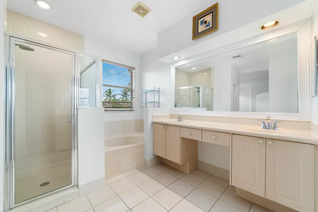 a spacious bathroom with a shower sink and mirror