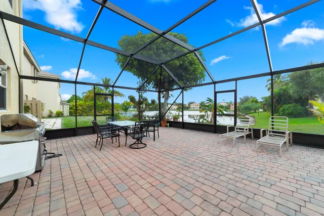 a view of a patio with a table and chairs under an umbrella