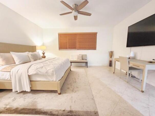 3567 Commodore Circle Delray Beach, FL 33483 - Photo 22 of 76 a spacious bedroom with a bed and a flat screen tv