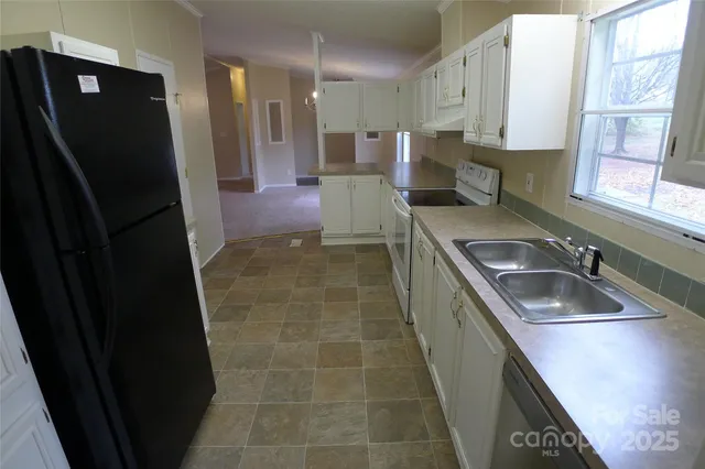 a view of livingroom and chandelier fan