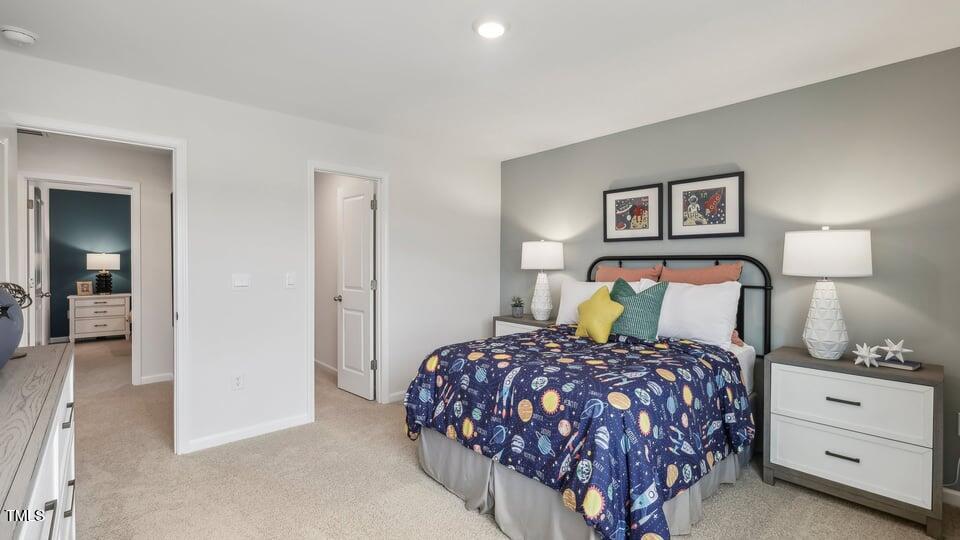 705 Holstein Dairy Way Wake Forest, NC 27587 - Photo 27 of 42 a bedroom with a bed and a lamp on dresser