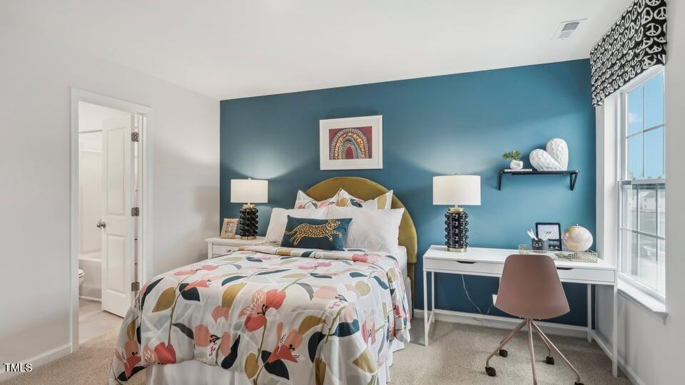 705 Holstein Dairy Way Wake Forest, NC 27587 - Photo 30 of 42 a bedroom with a bed and a lamp on dresser