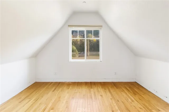 a view of a room with wooden floor and a window