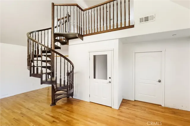 a view of an entryway with wooden floor