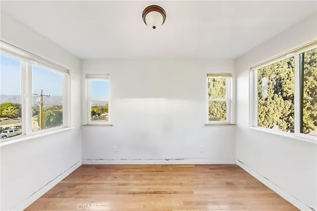 a view of room with window and hardwood floor