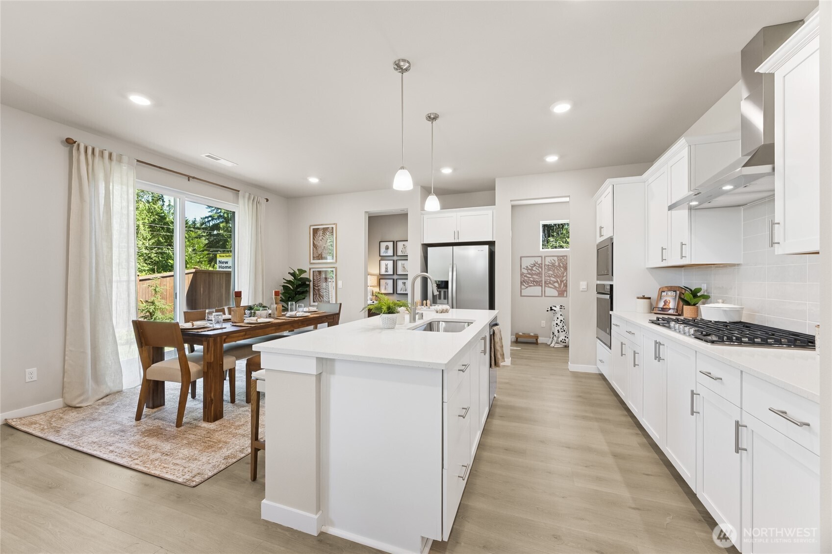26866 Northeast 143rd Circle, Unit 19 Duvall, WA 98019 - Photo 12 of 29 a large kitchen with stainless steel appliances kitchen island granite countertop a lot of counter space and a refrigerator