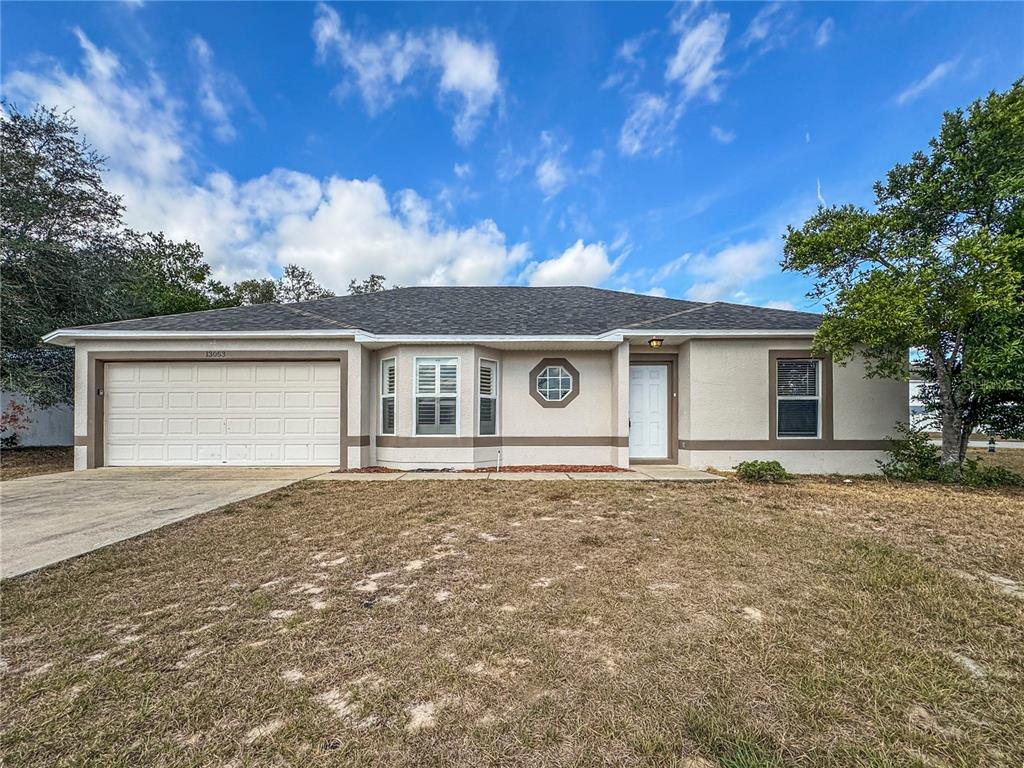 Undisclosed Address Spring Hill, FL 34609 - Photo 1 of 18 front view of house with a yard