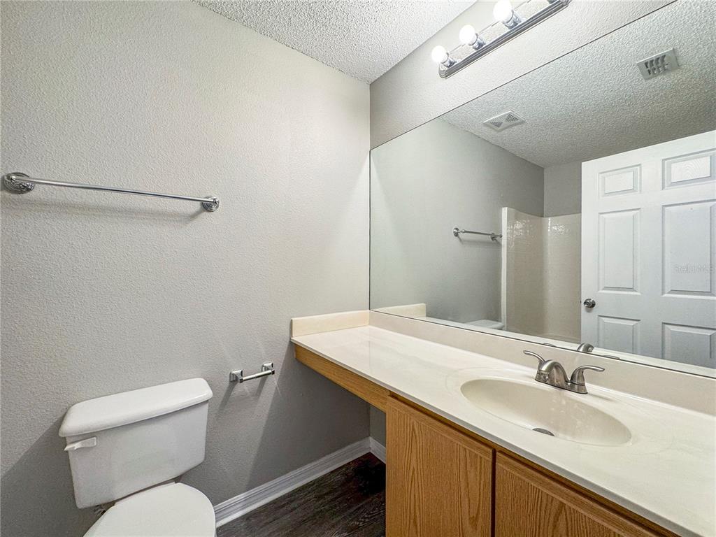 Undisclosed Address Spring Hill, FL 34609 - Photo 13 of 18 a bathroom with a toilet sink and mirror