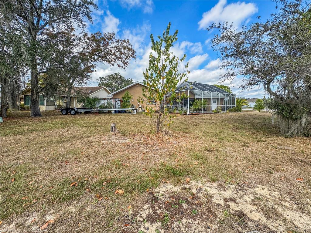 Undisclosed Address Spring Hill, FL 34609 - Photo 15 of 18 a front view of a house with a yard and garage