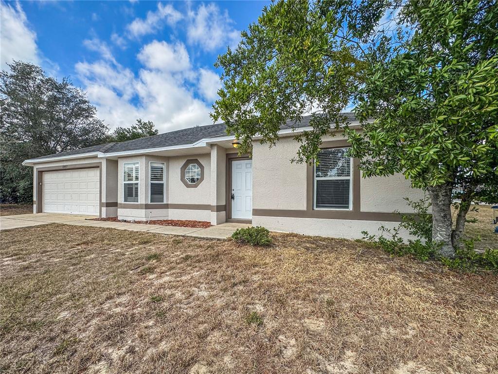 Undisclosed Address Spring Hill, FL 34609 - Photo 17 of 18 front view of a house with a yard