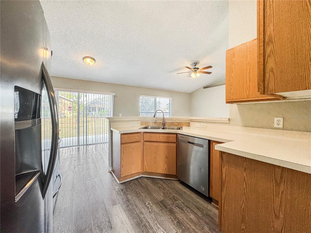 Undisclosed Address Spring Hill, FL 34609 - Photo 6 of 18 a kitchen with stainless steel appliances granite countertop a sink a stove and refrigerator