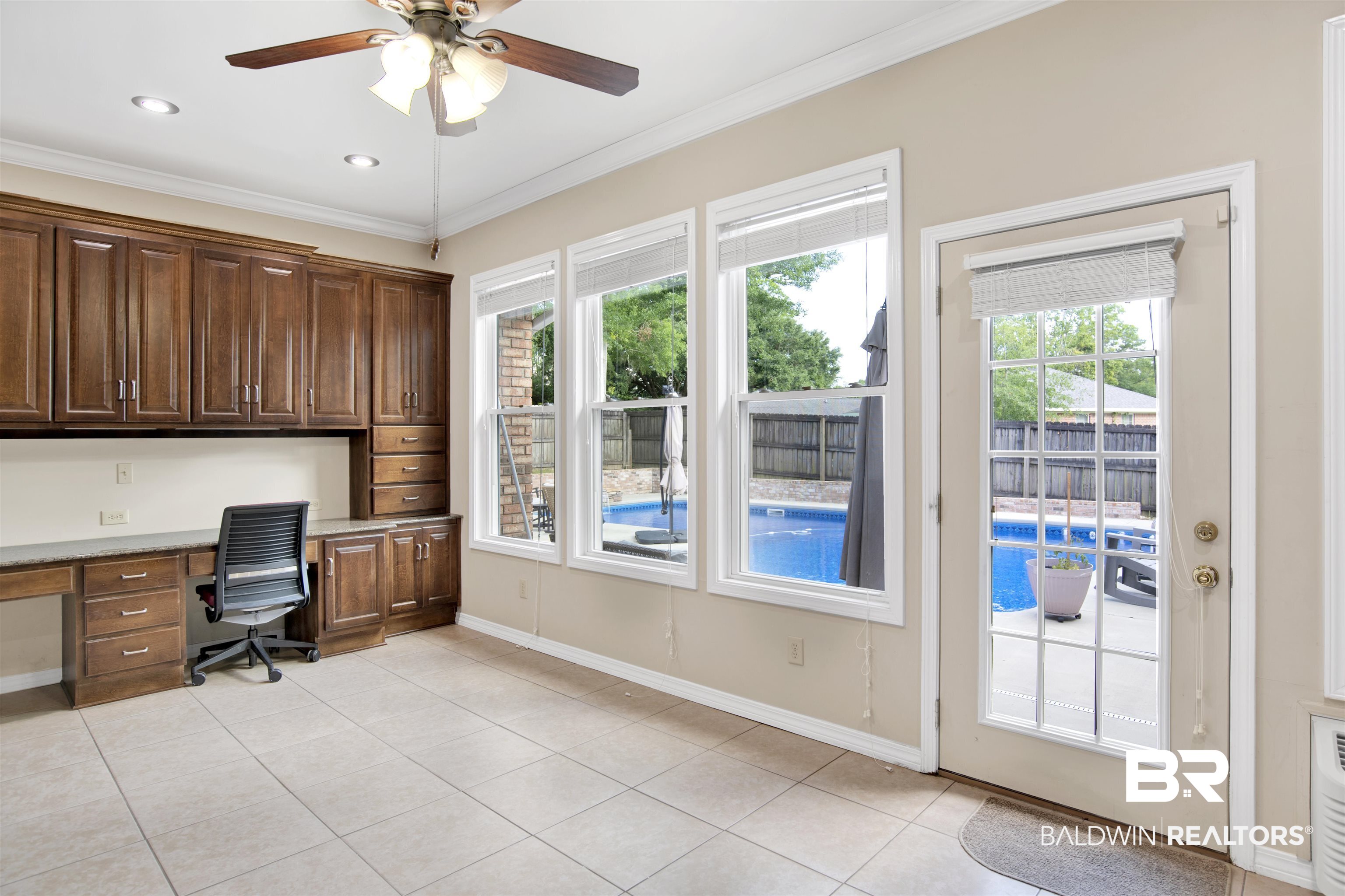 7431 Summer Court Mobile, AL 36695 - Photo 37 of 37 Home office with built in desk, a ceiling fan, light tile patterned flooring, crown molding, and baseboards