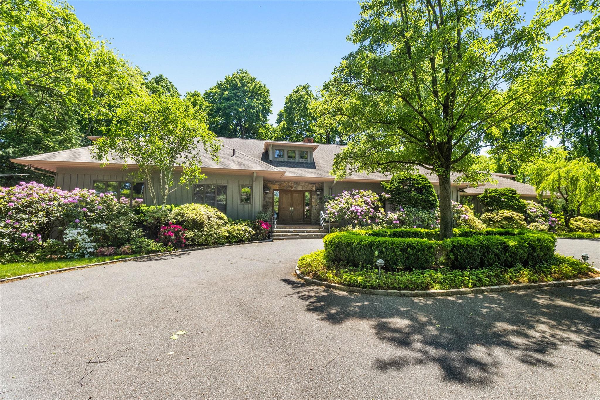 a front view of a house with a yard and outdoor seating