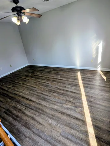a view of a room with wooden floor