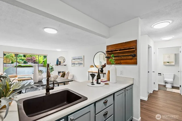 a kitchen with a sink and a stove top oven