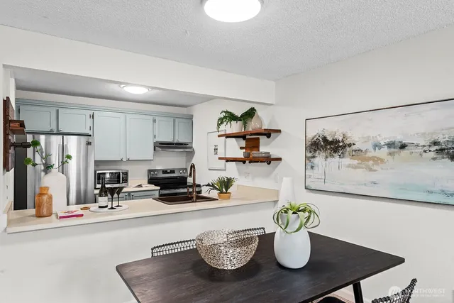a dining room with furniture and potted plant