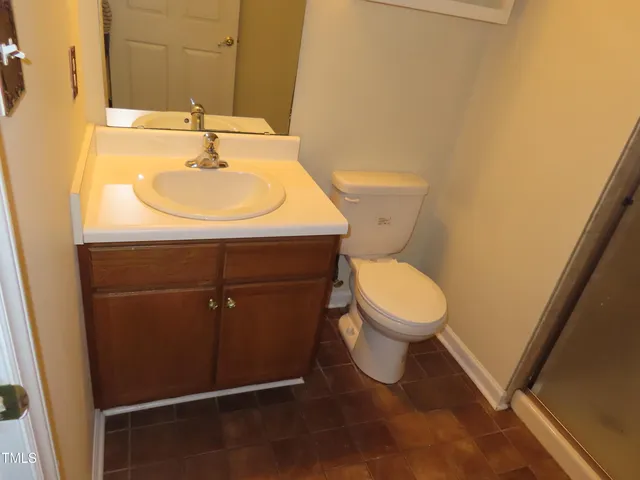 a bathroom with a glass shower door