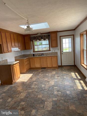 1296 Rawlinsville Road New Providence, PA 17560 - Photo 5 of 8 a large kitchen with kitchen island granite countertop a sink window and a refrigerator