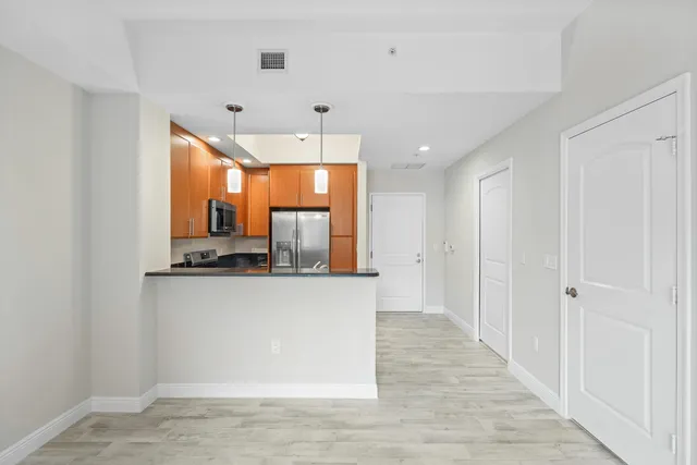a kitchen with stainless steel appliances a stove a refrigerator and a refrigerator