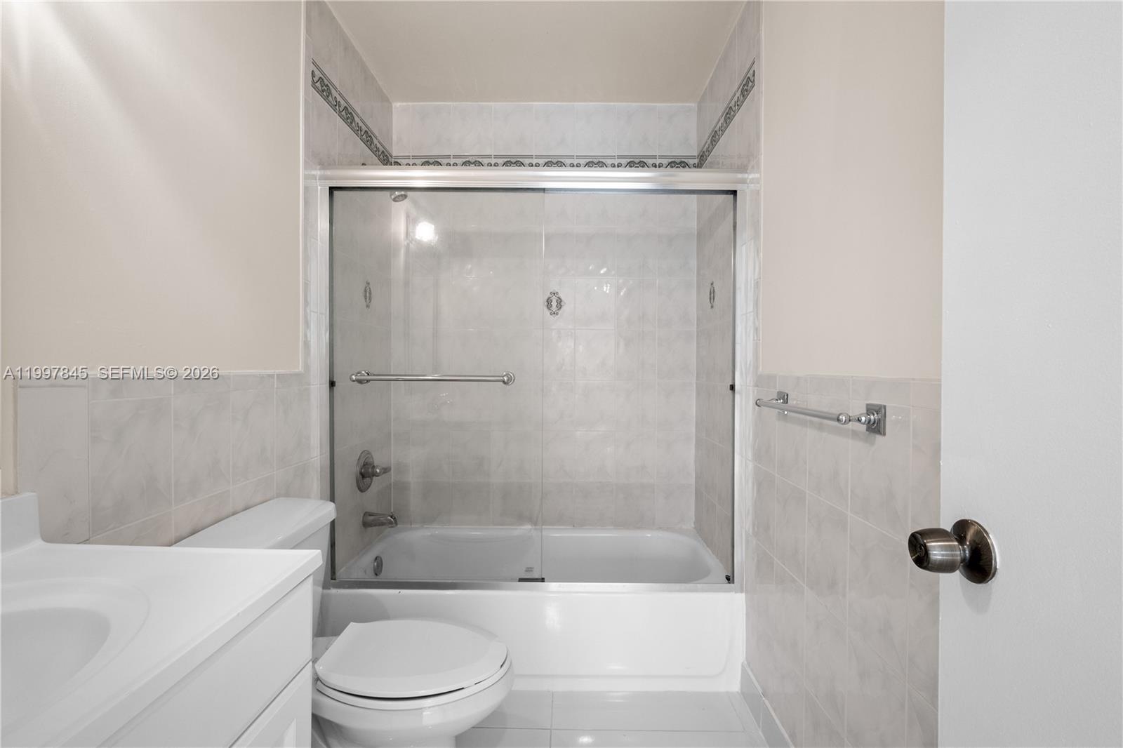 6211 Southwest 138th Court, Unit B Miami, FL 33183 - Photo 20 of 27 a bathroom with a shower a toilet and a tub