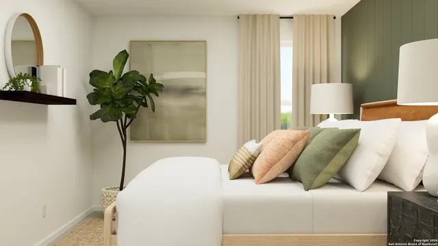 a bedroom with a bed and a potted plant