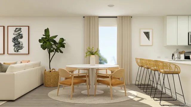 a dining room with furniture and a potted plant