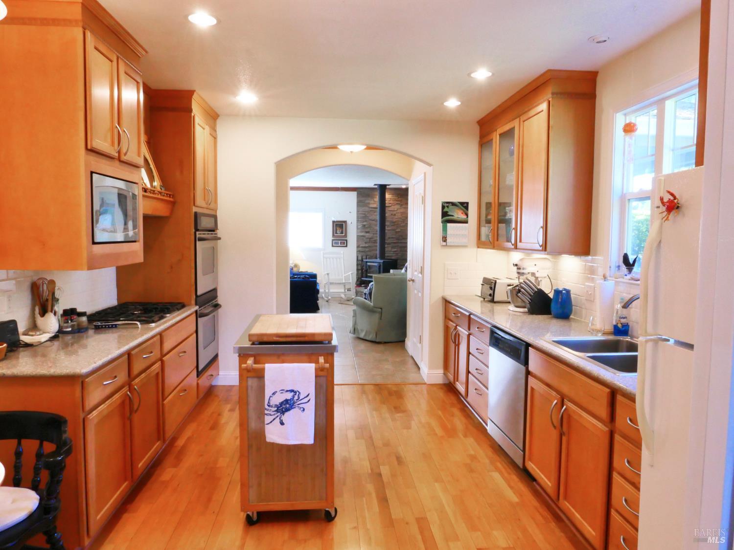 30860 Simpson Lane Fort Bragg, CA 95437 - Photo 12 of 33 a large kitchen with stainless steel appliances granite countertop a stove a sink and a refrigerator