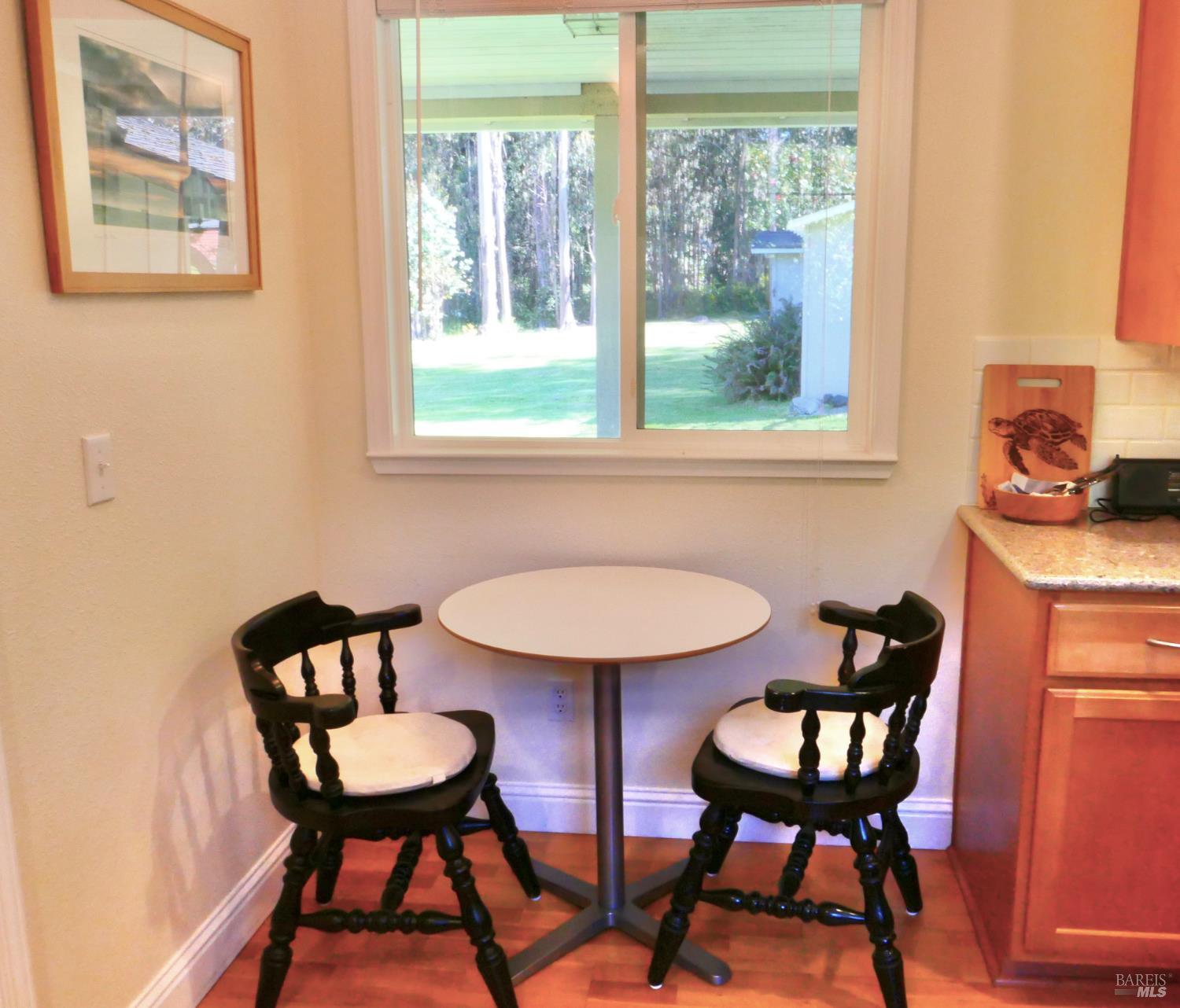 30860 Simpson Lane Fort Bragg, CA 95437 - Photo 14 of 33 a view of a dining room with furniture and a window