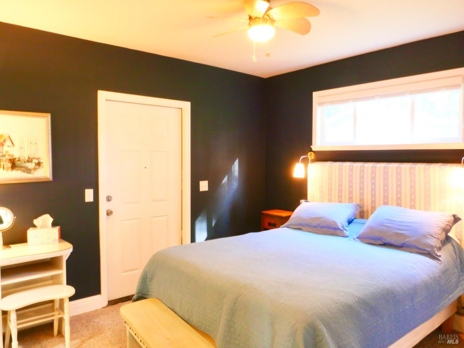 30860 Simpson Lane Fort Bragg, CA 95437 - Photo 17 of 33 a bedroom with a bed and a lamp