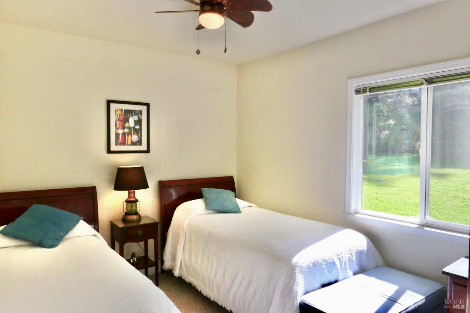 30860 Simpson Lane Fort Bragg, CA 95437 - Photo 19 of 33 a bedroom with two beds and a large window