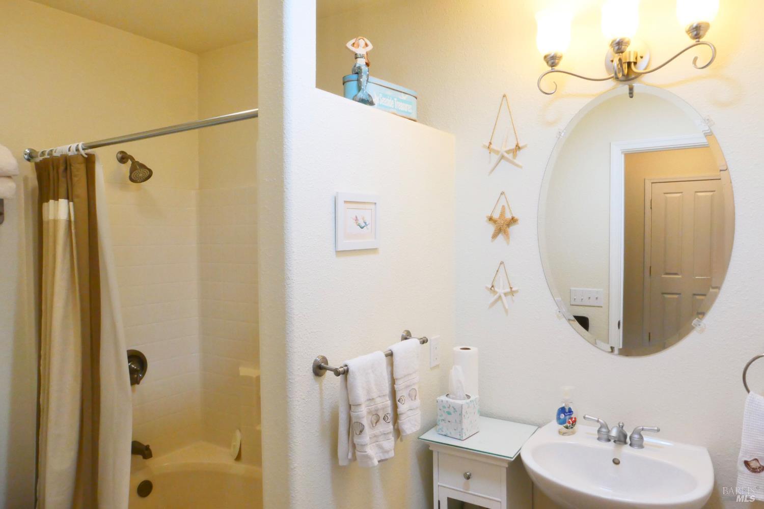 30860 Simpson Lane Fort Bragg, CA 95437 - Photo 21 of 33 a bathroom with a sink a mirror a vanity and shower