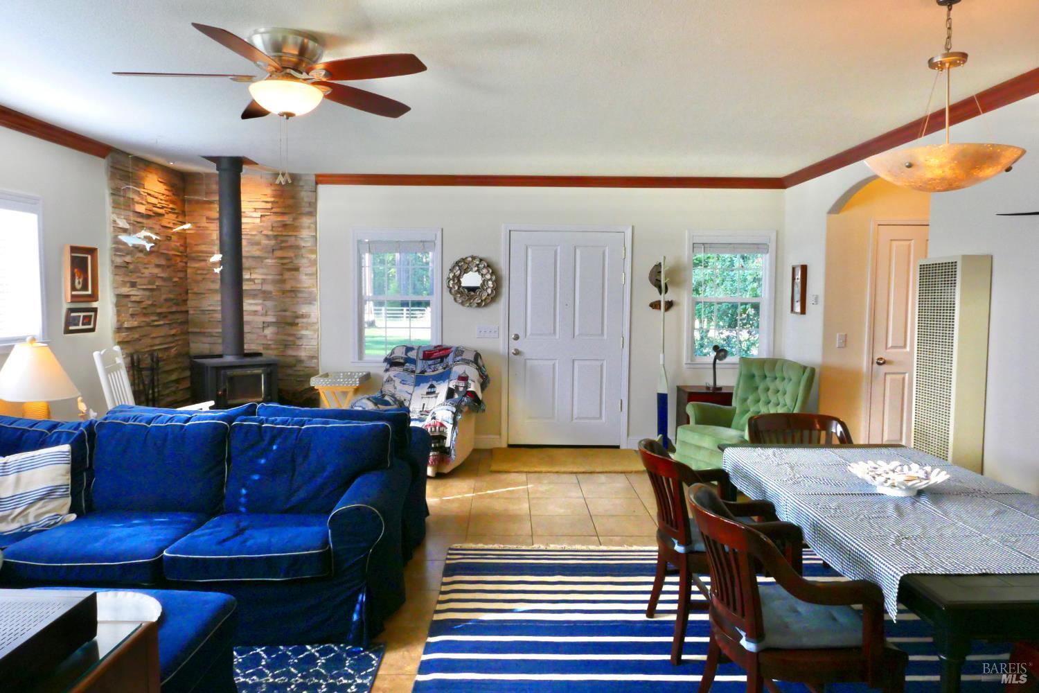 30860 Simpson Lane Fort Bragg, CA 95437 - Photo 7 of 33 a living room with furniture a flat screen tv and a large window